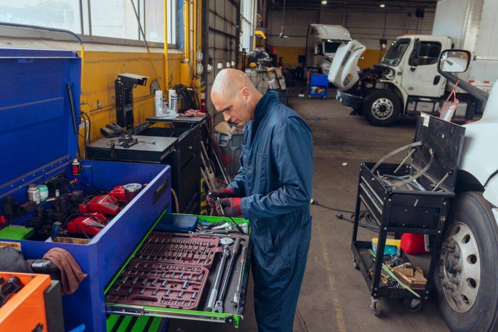 Mechanic working with tools in truck repair garage